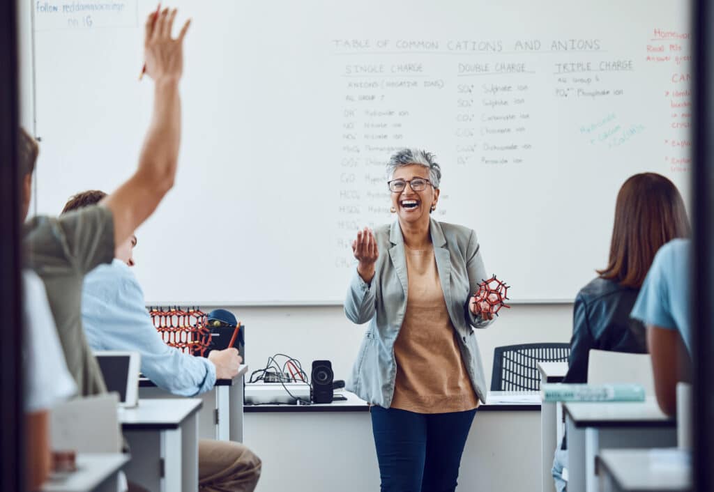 Classroom with happy teacher at the front of the class nurture happiness concept