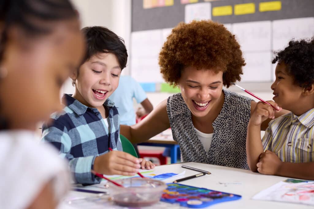 positive school culture concept female teacher smiling with students