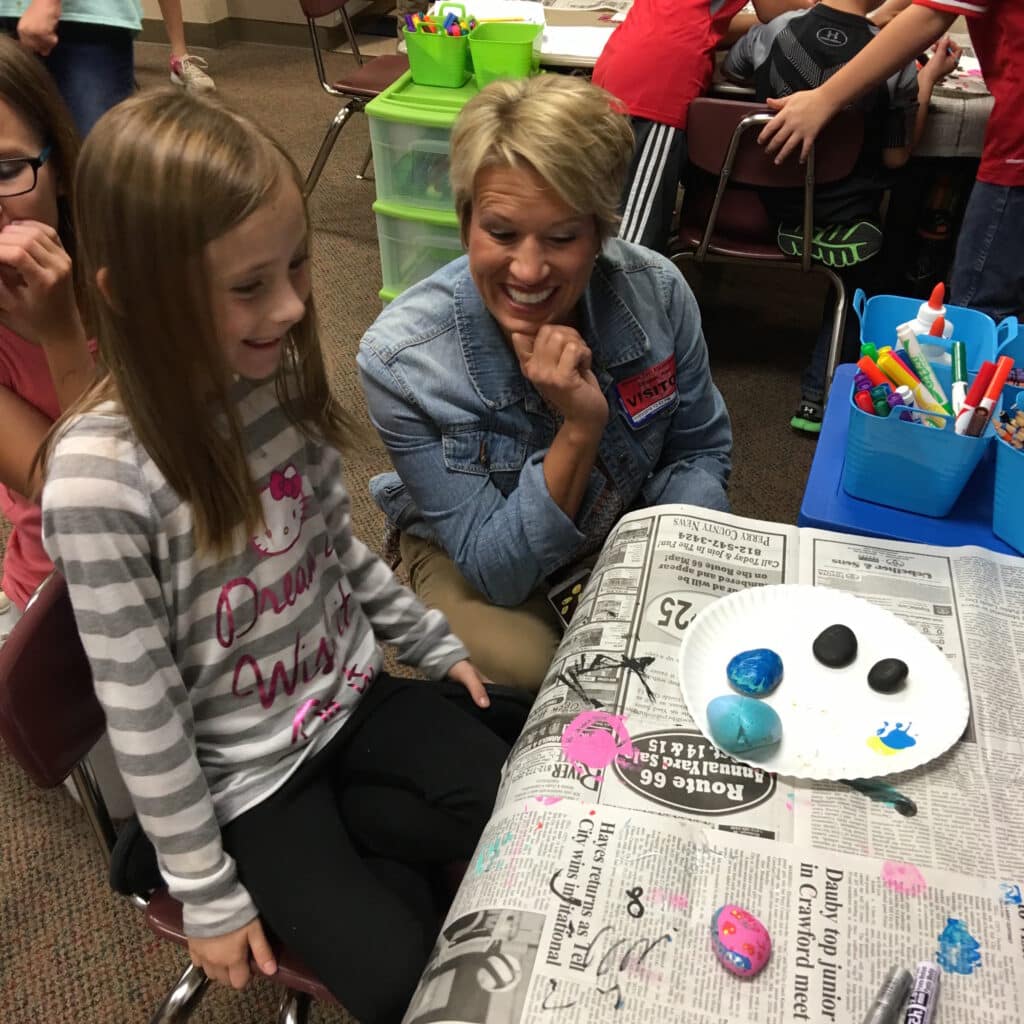 Kim Strobel with students practicing social emotional learning practices