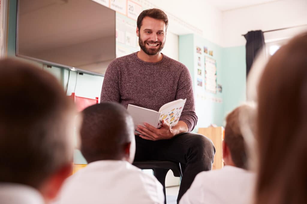 structured literacy concept with a Male Teacher Reading to classroom