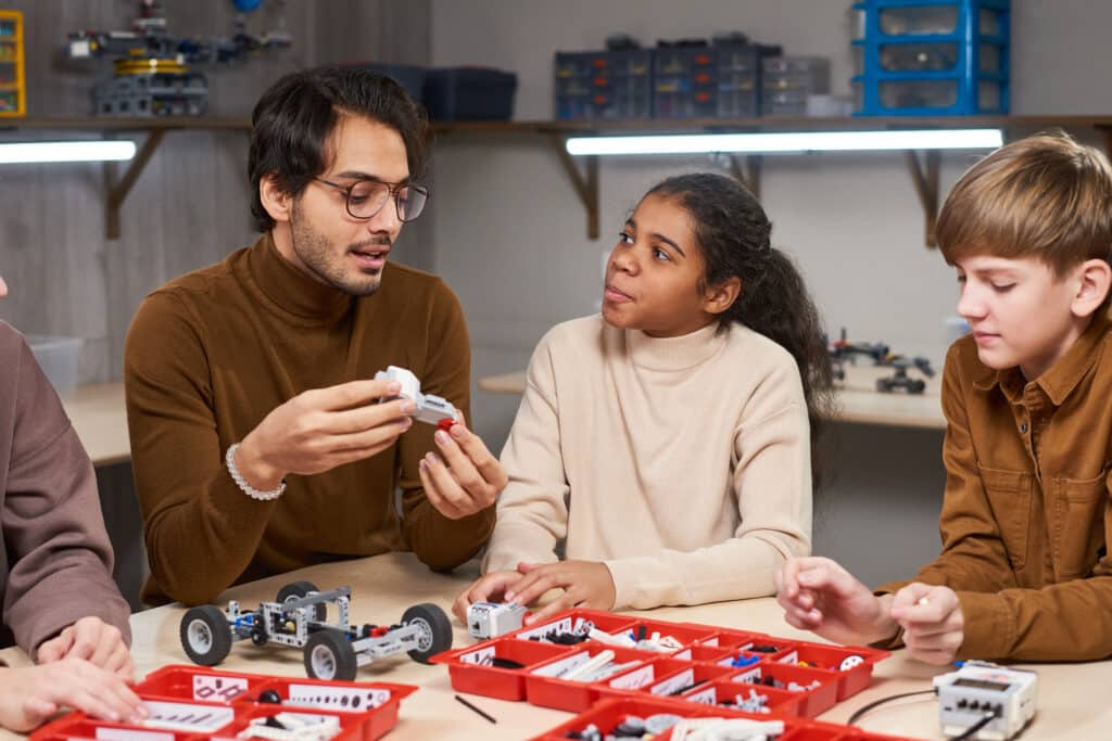 Teacher projecting robots with children in project-based learning activity