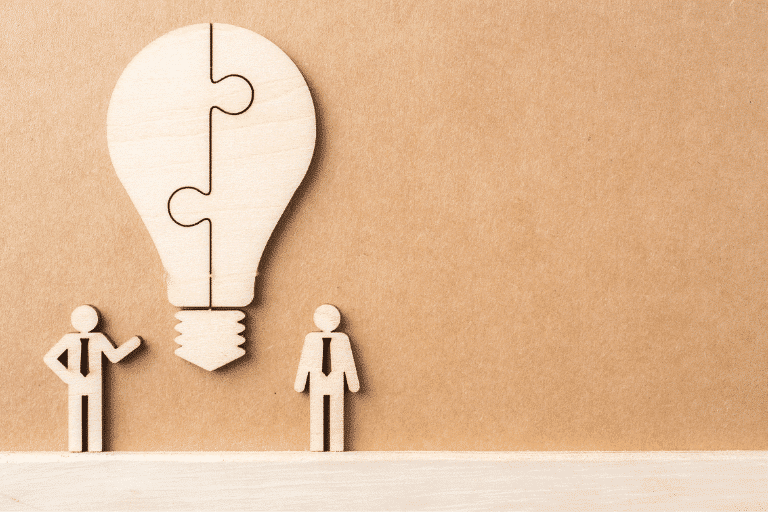 Light bulb puzzle piece with two men underneath.