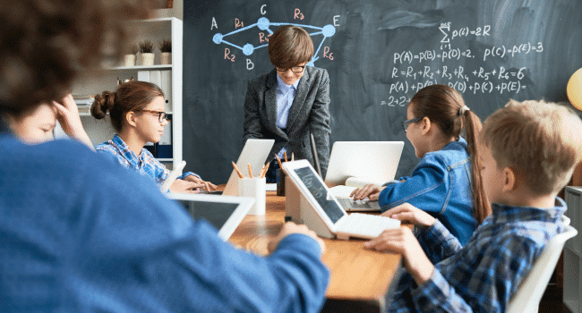 teachers and students using their laptops inside the classroom