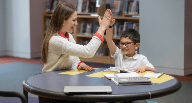Teacher one-on-one teaching with a student.